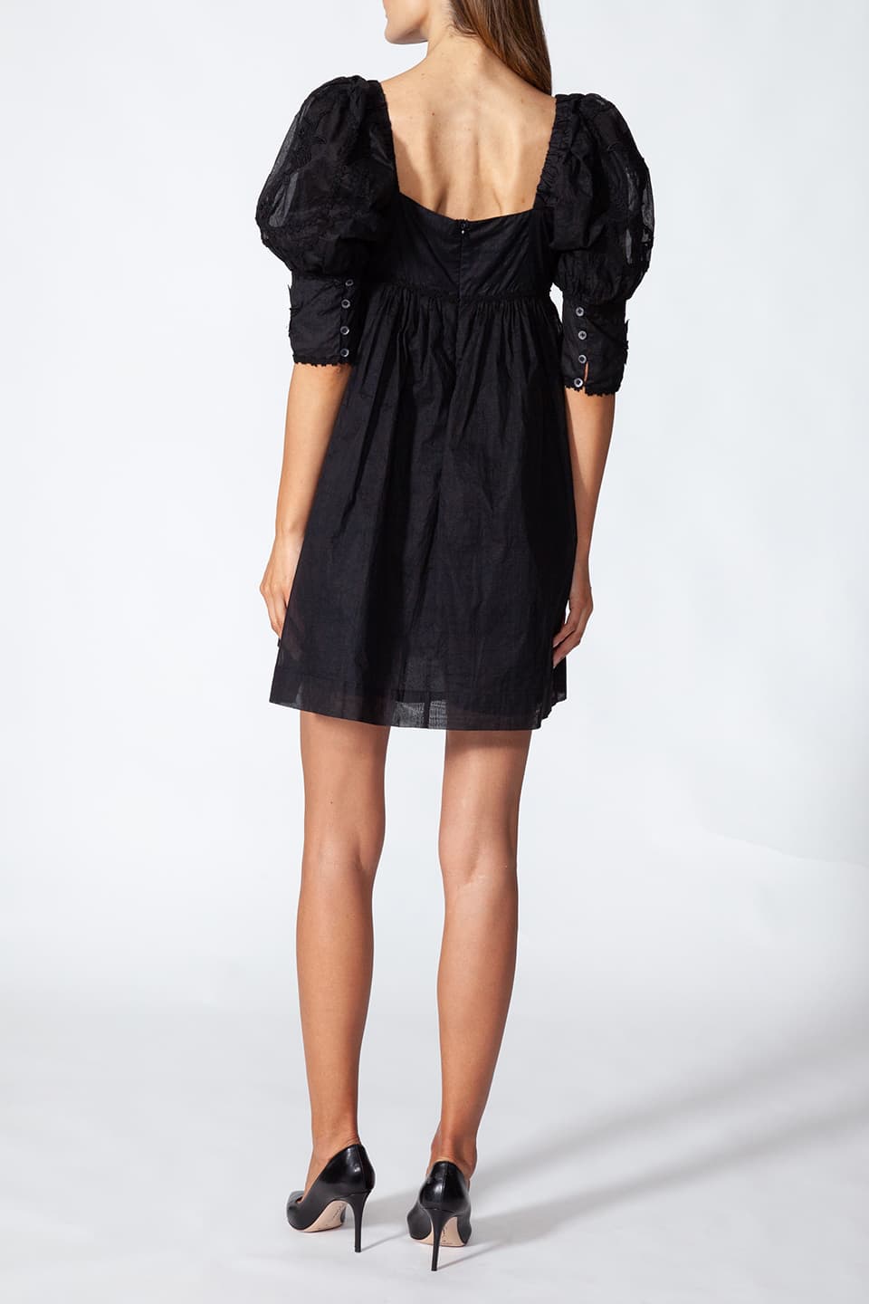 Fashion designer short dress in black color with floral embroidery, product view from behind