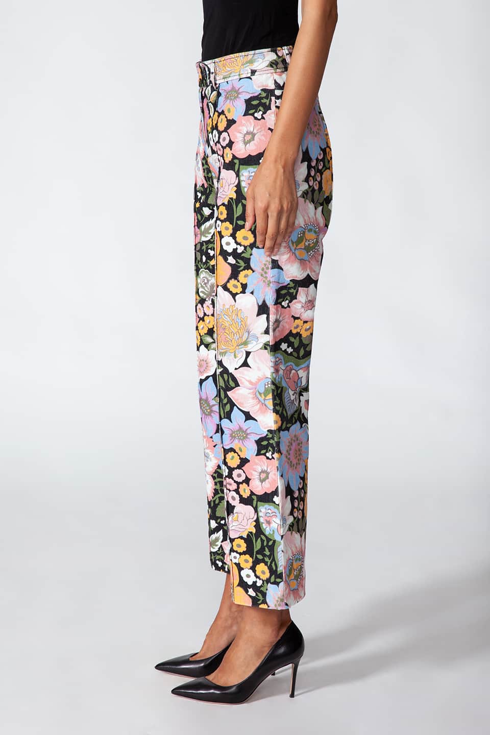 Model showing Manoush European stylist's flare trousers in corduroy with floral print, posing from left side