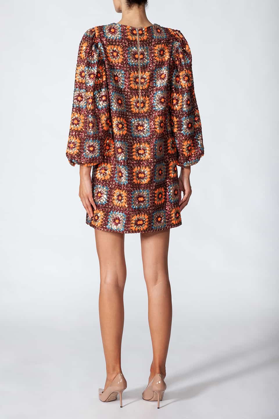Woman in pose from behind, wearing short sequined dress in sequin crochet with long puffy sleeves in brown color. Dress from Manoush European Fashion Stylist collection.