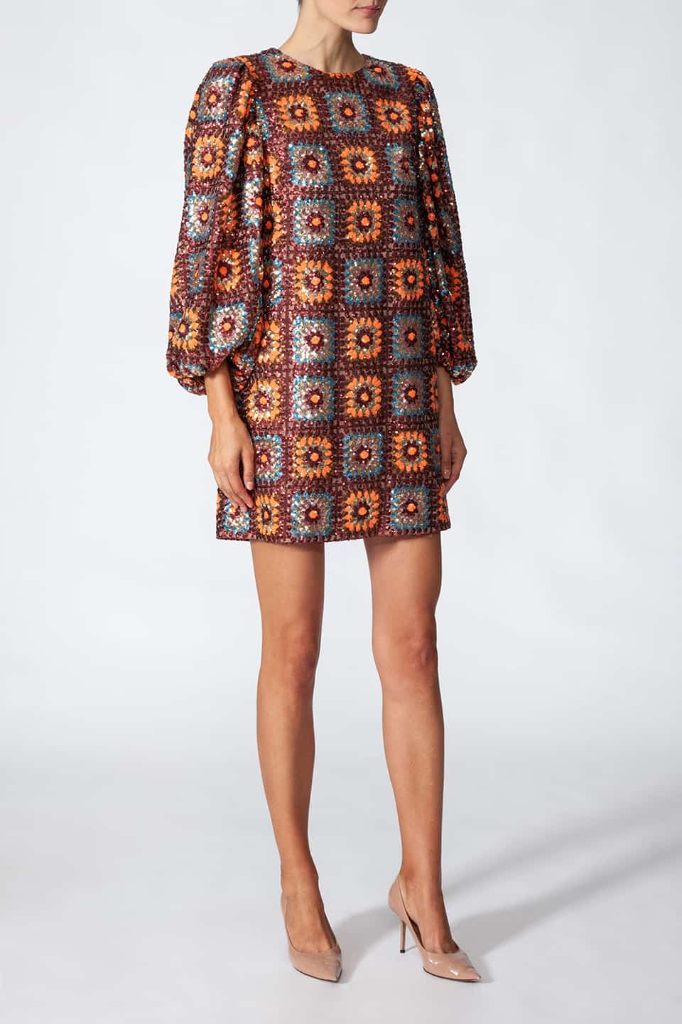 Woman in pose from left side, wearing short sequined dress in sequin crochet with long puffy sleeves in brown color. Dress from Manoush European Fashion Stylist collection.