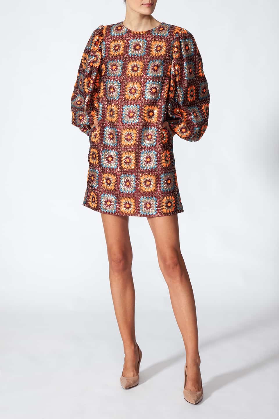 Woman in pose, wearing short sequined dress in sequin crochet with long puffy sleeves in brown color. Dress from Manoush European Fashion Stylist collection.