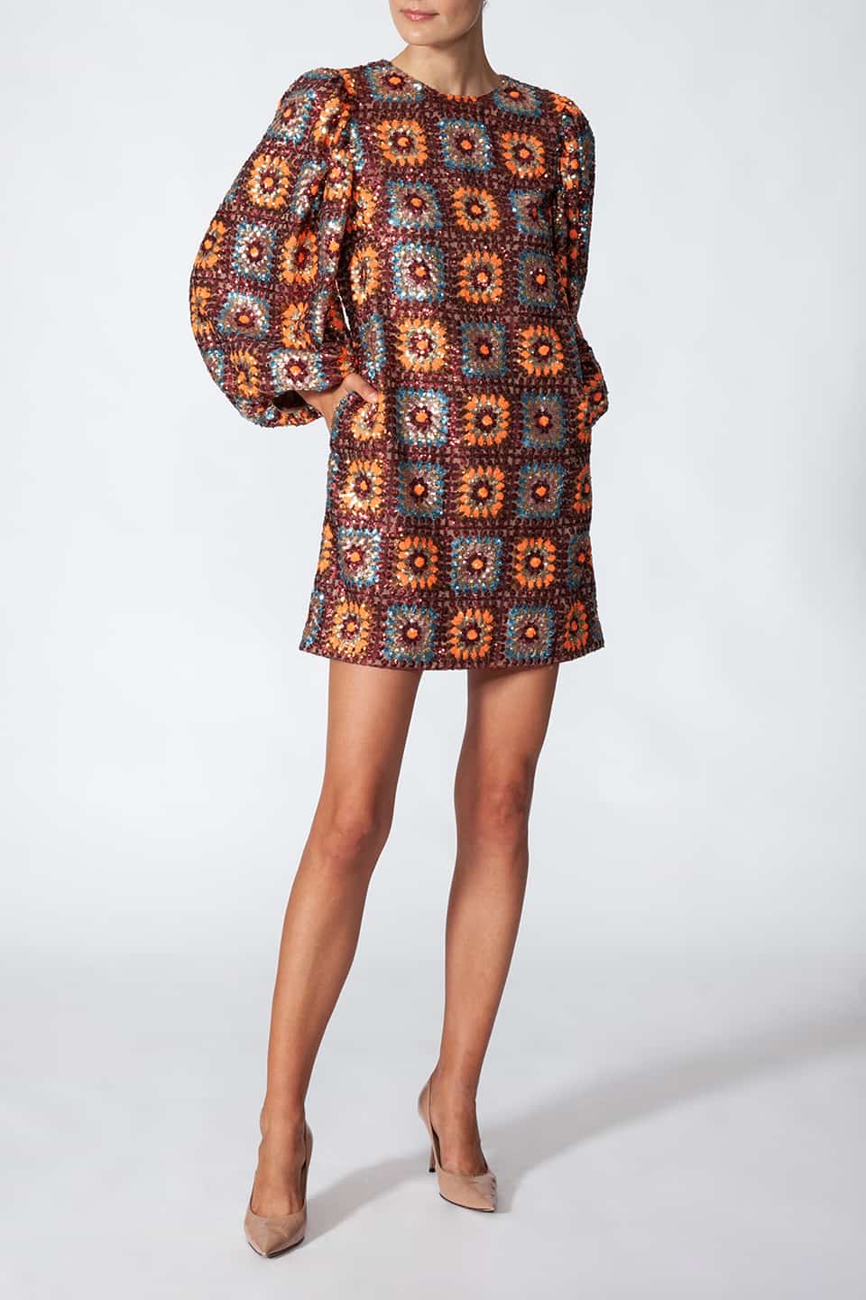 Woman in pose for front view, wearing short sequined dress in sequin crochet with long puffy sleeves in brown color. Dress from Manoush European Fashion Stylist collection.
