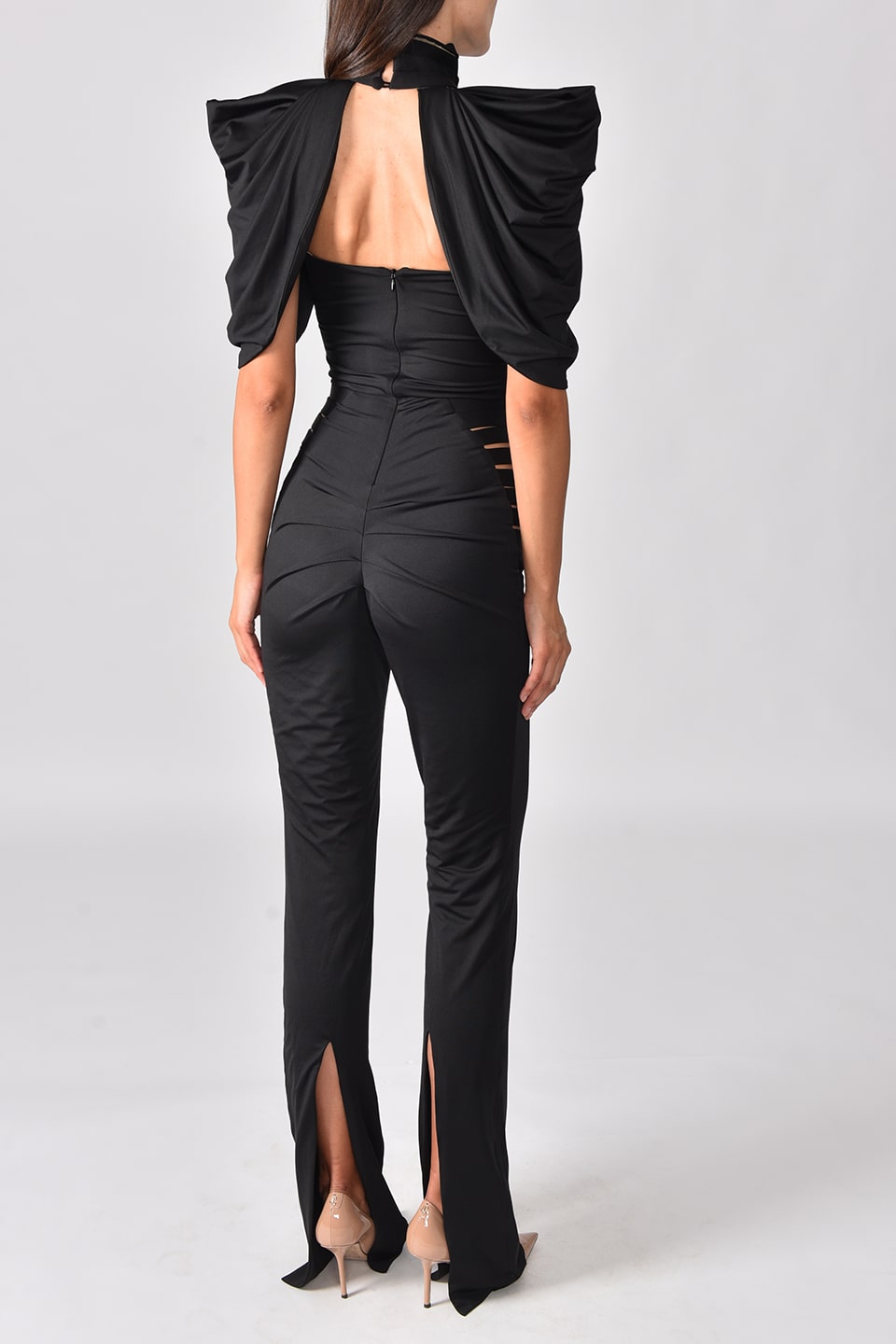 Fashion designer jumpsuit for special occasions, in black color and stretchy material. behind detail view