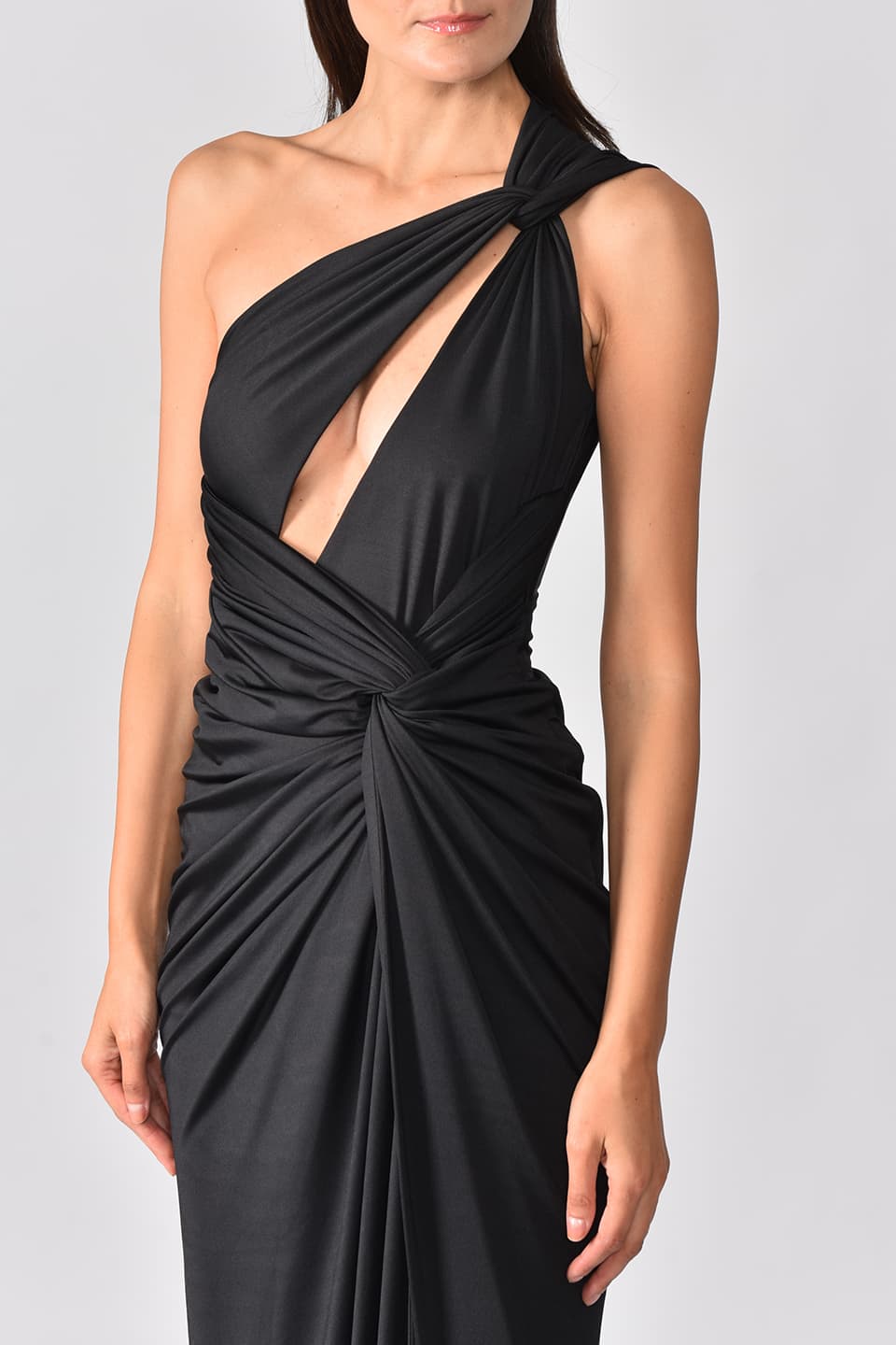 Model wearing black one shoulder dress with long side slit from Hamel fashion designer, showing front details