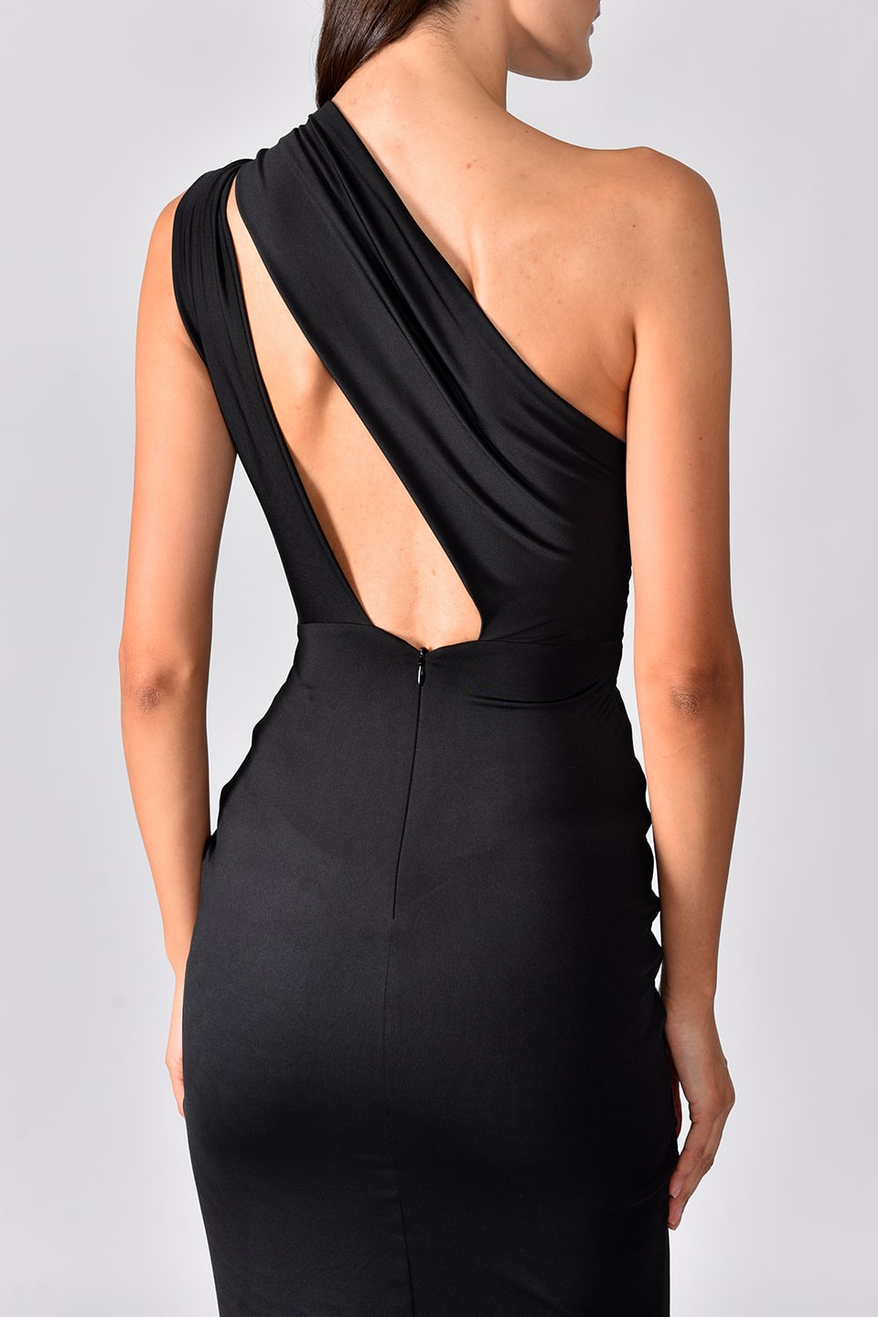 Thumbnail for Product gallery 7, Model wearing black one shoulder dress with long side slit from Hamel fashion designer, details of the back side