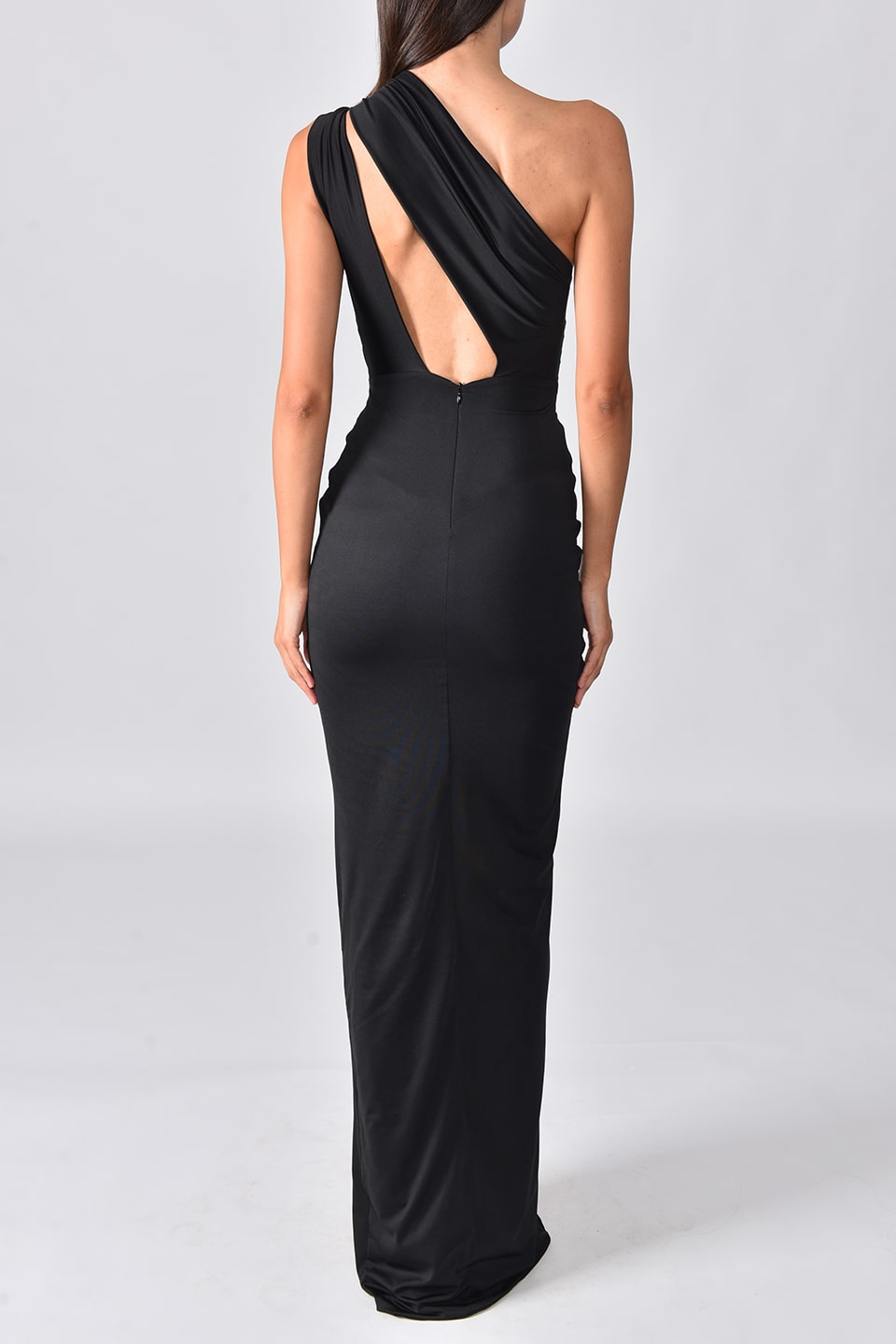 Model wearing black one shoulder dress with long side slit from Hamel fashion designer, posing from behind