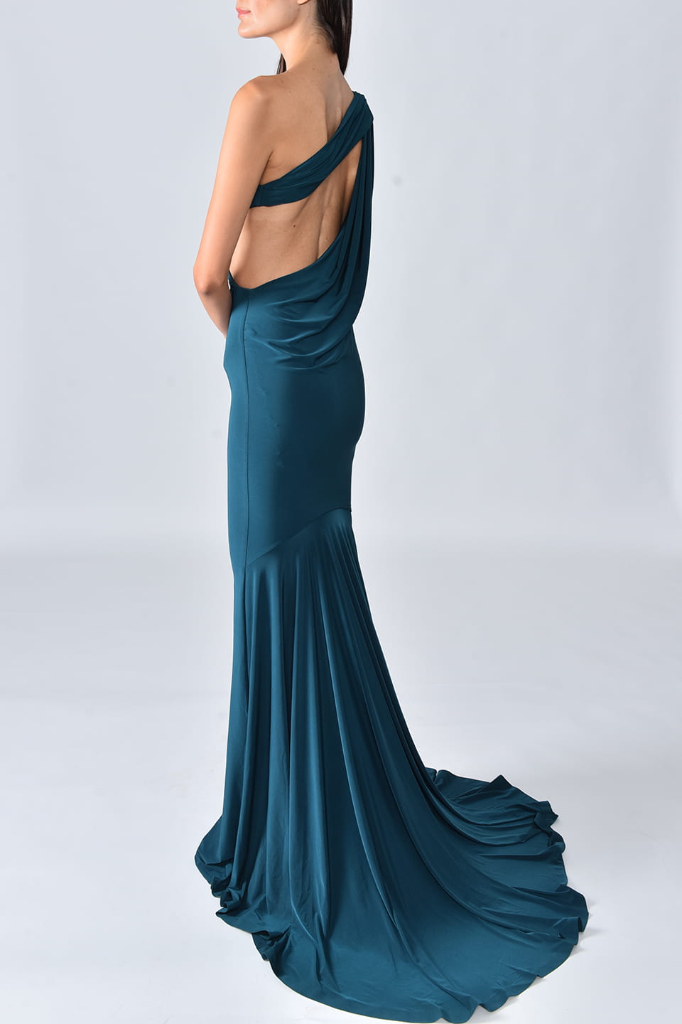 Model wears Special occasion Maxi dress in Petrol Blue color from Hamel fashion stylist, posing from left - back side