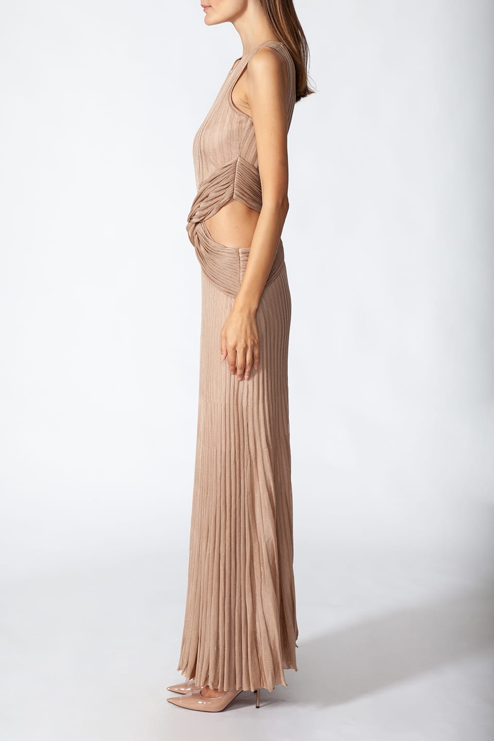 Model posing on a side, wearing Fashion Stylist Kukhareva London's elegant gold dress. Long evening dress crafted from gold viscose blend featuring round neckline.