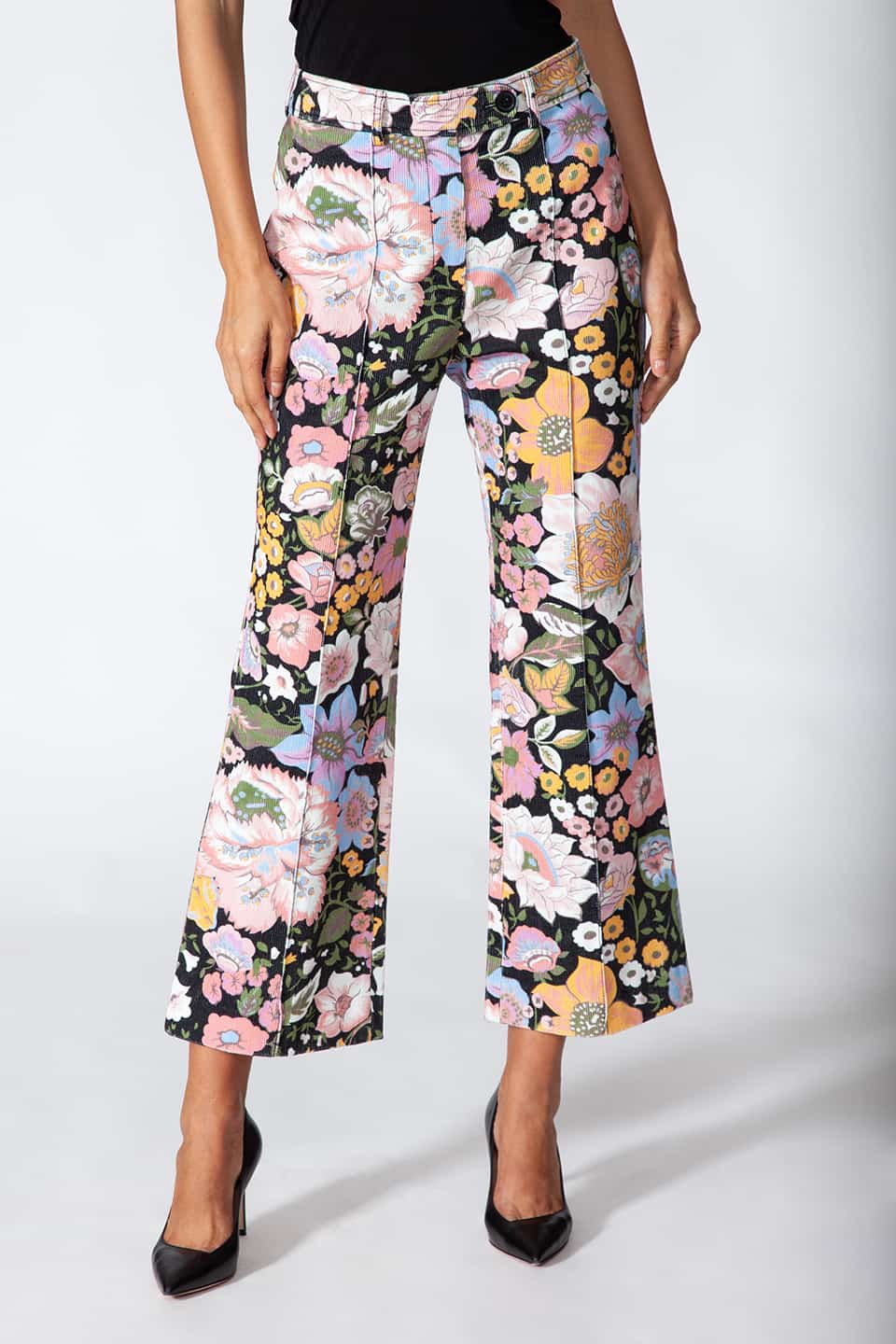 Model showing Manoush European stylist's flare trousers in corduroy with floral print, in pose for front view. Product gallery 1