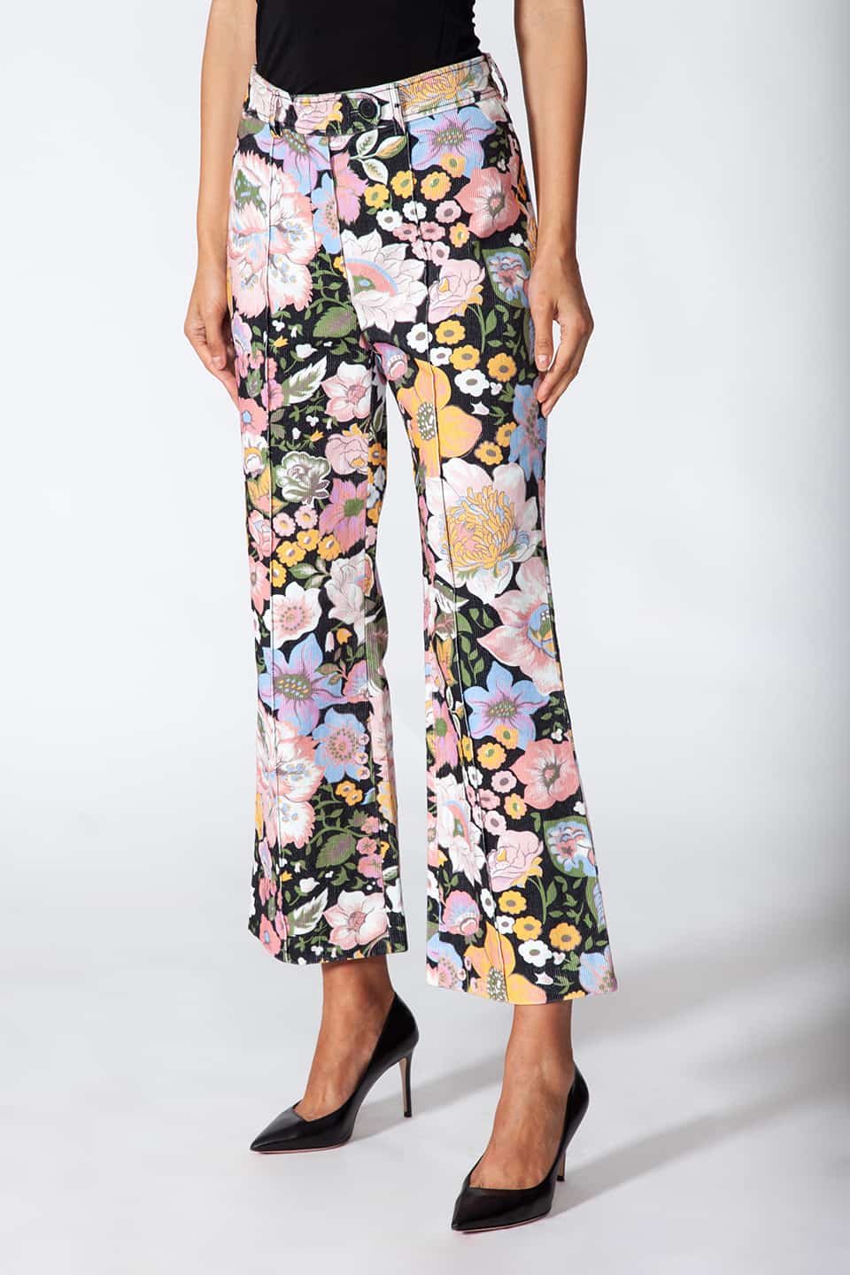 Model showing Manoush European stylist's flare trousers in corduroy with floral print, in pose for side view