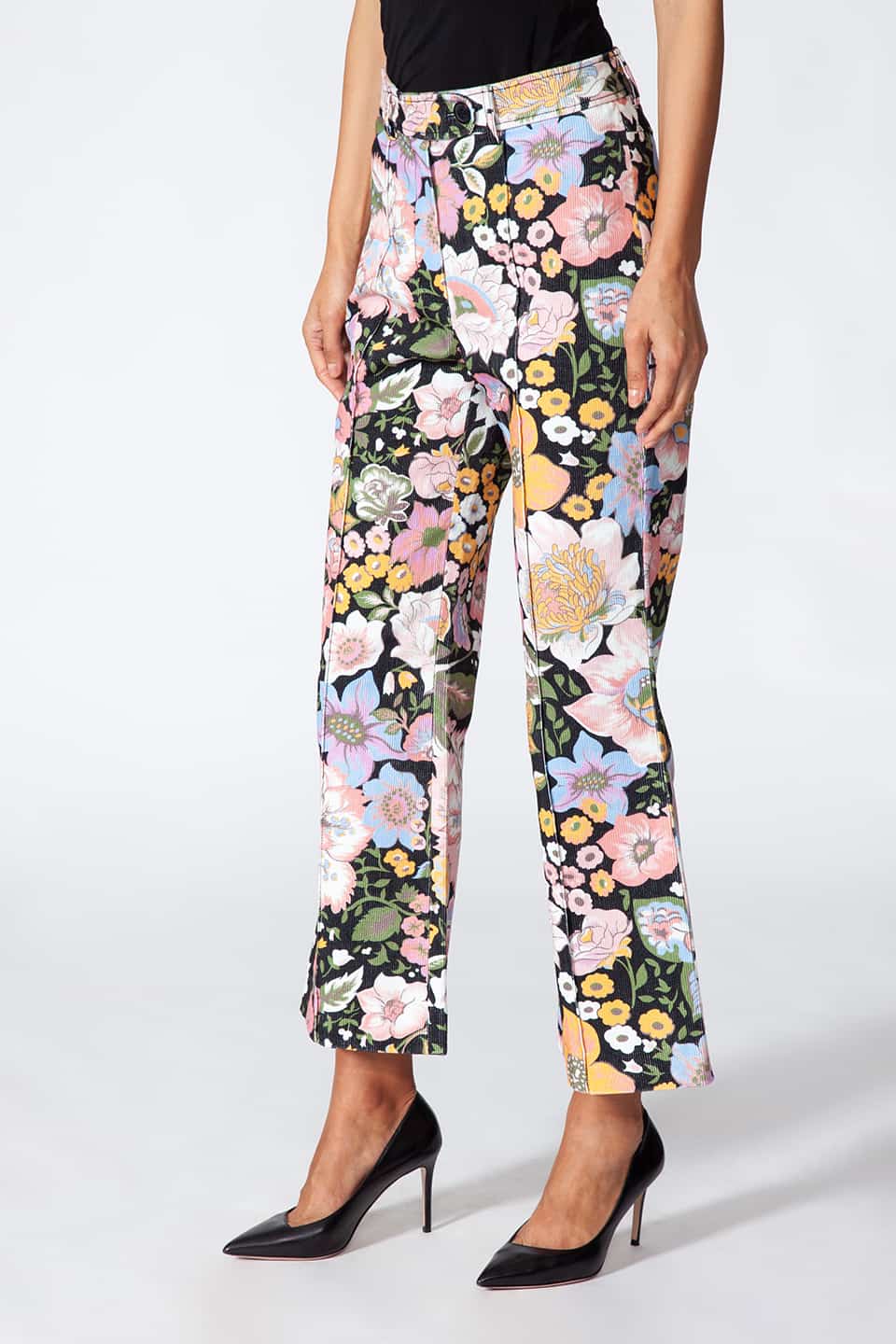 Model showing Manoush European stylist's flare trousers in corduroy with floral print, in pose from a detailed side view