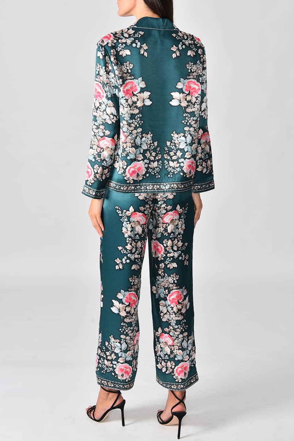 Model wearing satin pyjama style jacket from fashion designer Vilshenko, posing full body from behind