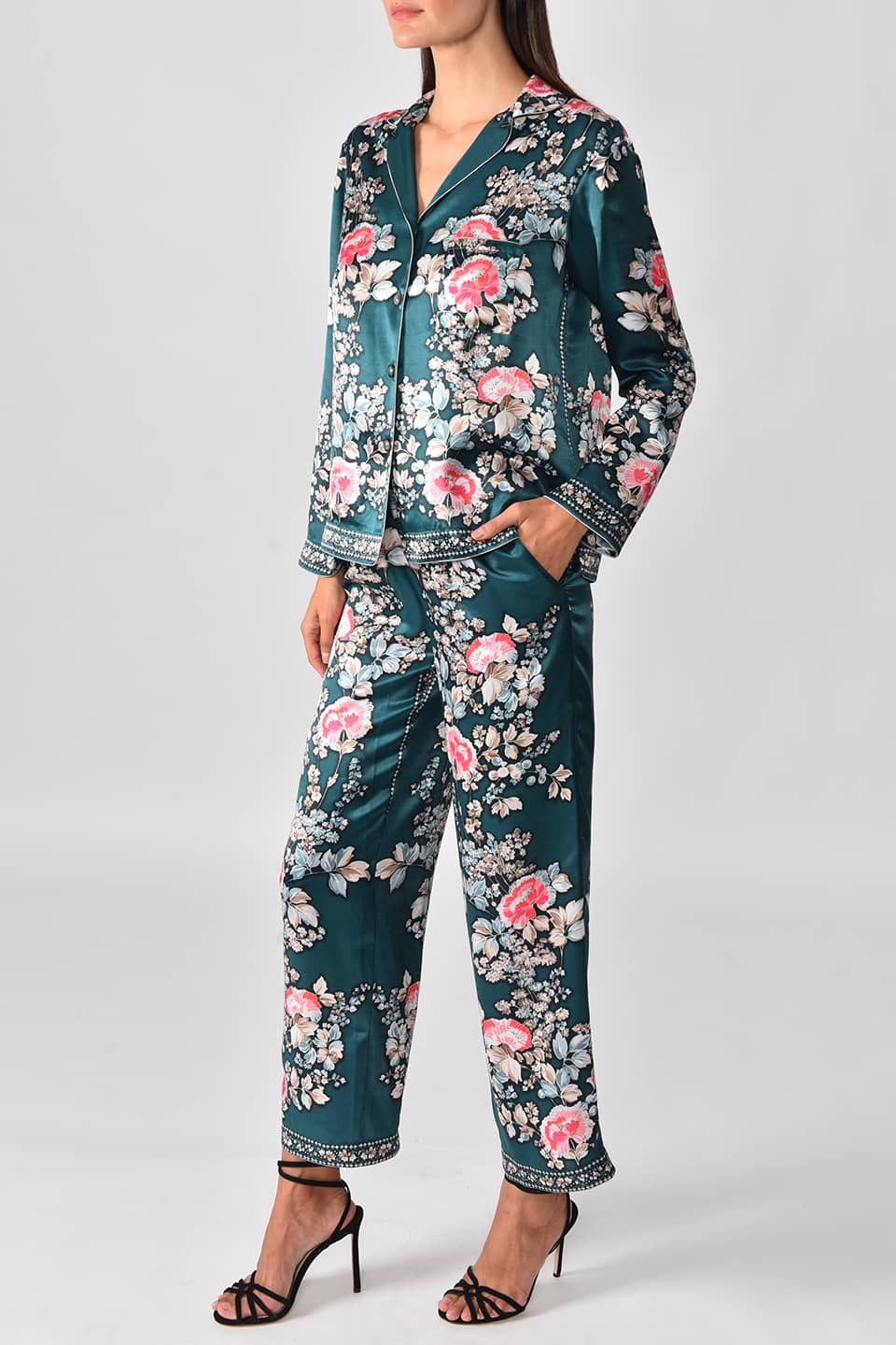 Model wearing satin pyjama style jacket from fashion designer Vilshenko, posing full body on left side