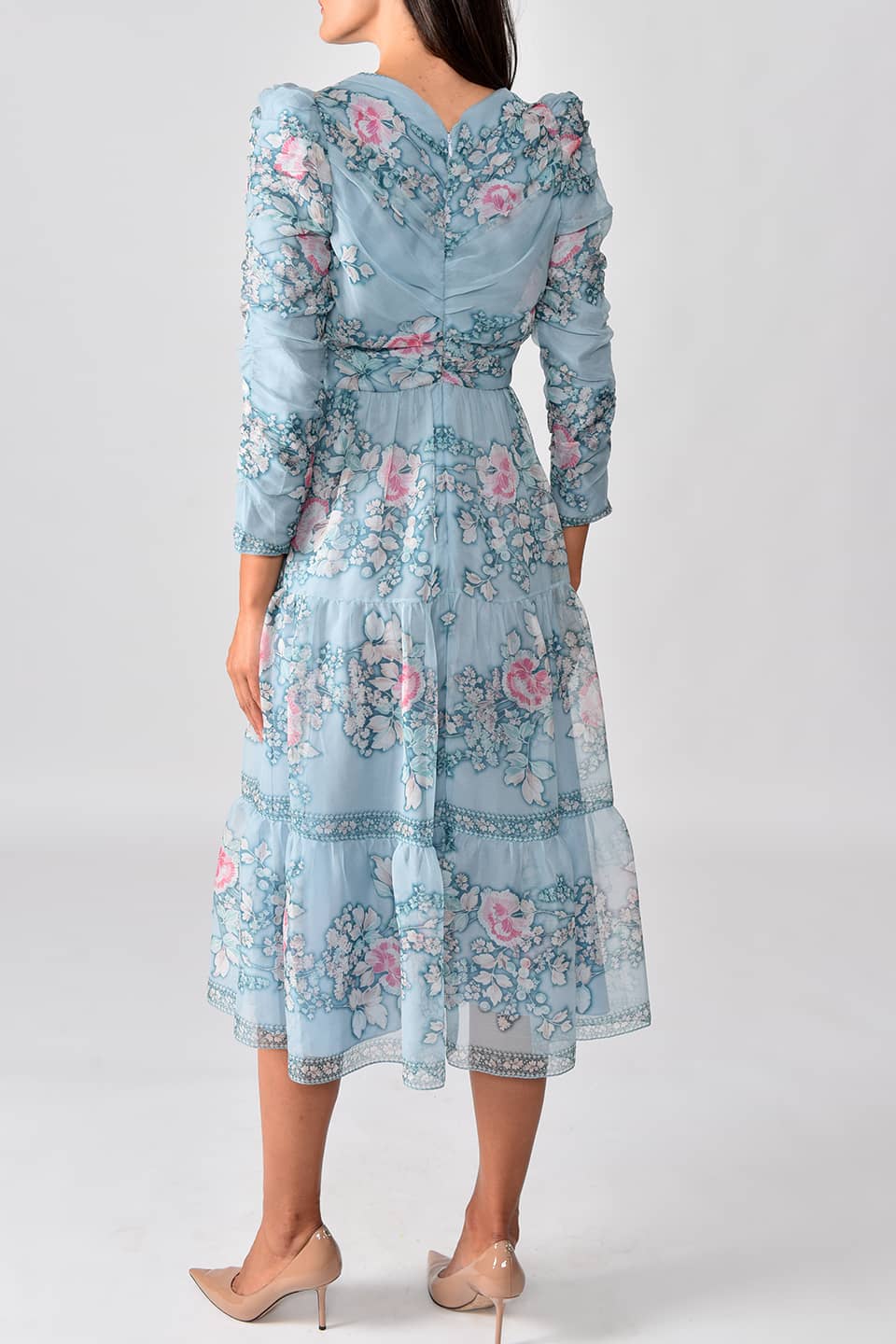 Thumbnail for Product gallery 2, Model wearing floral print silk chiffon tiered long dress in a pale blue color from stylist Vilshenho, posing from behind 