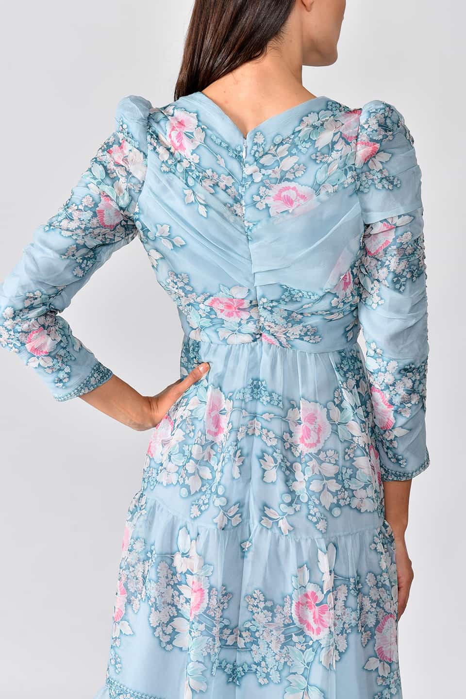Thumbnail for Product gallery 8, Model wearing floral print silk chiffon tiered long dress in a pale blue color from stylist Vilshenho, posing from behind